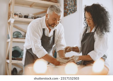 Adult senior couple at artwork in pottery - Powered by Shutterstock