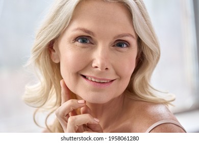 Adult Senior Older Woman Touching Perfect Soft Face Skin With Hand. Portrait Of Mid Age 50 Years Old Woman Advertising Facial Lift Products Salon Skin Care Isolated On White Looking At Camera.