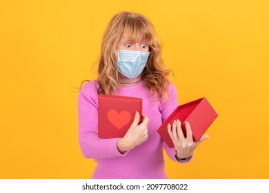 adult or senior woman with face mask isolated on background with gift box with heart - Powered by Shutterstock