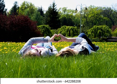 Adult Sisters In A Park At Wonderful Day