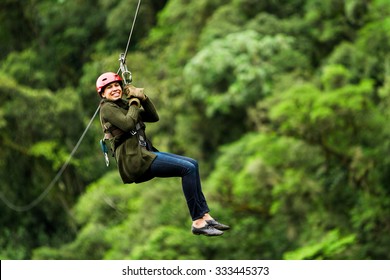 Adult Slim Afro Woman On Zip Line In Ecuadorian Rainforest Nearby Banos De Agua Santa