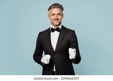 Adult smiling barista male waiter butler man wear shirt black suit bow tie elegant uniform work at cafe point index finger camera on you isolated on plain blue background. Restaurant employee concept - Powered by Shutterstock