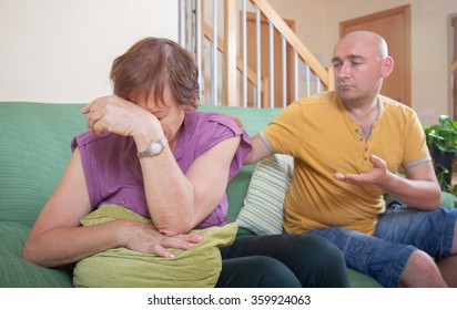 Adult Son And Elderly Mother During  Quarrel  At Home.