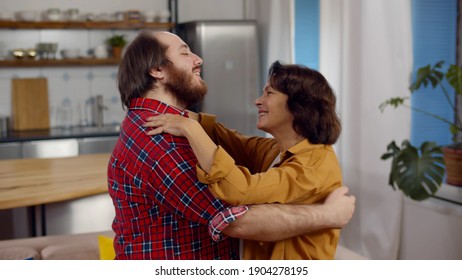 Adult Son And Senior Mum Dancing Waltz In Living Room. Portrait Of Happy Smiling Aged Woman Dancing With Young Son Relaxing And Having Fun Together At Home