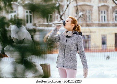 Adult Sportive Woman Runner Relax After Workout On Winter Day, Holding Travel Stainless Steel Mug With Hot Coffee. Reusable Water Bottle. Refuse, Reduce, Recycle And Zero Waste Concept.