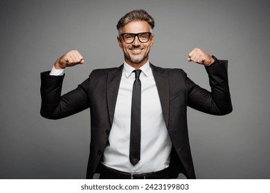 Adult strong happy fun successful employee business man corporate lawyer wear classic formal black suit shirt tie work in office show muscles on hand isolated on plain grey background studio portrait - Powered by Shutterstock