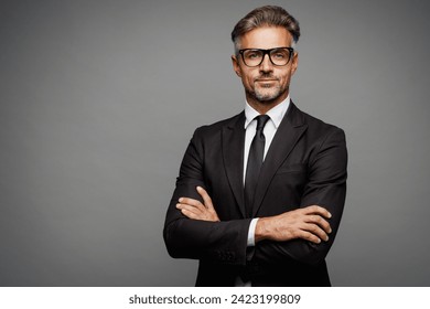 Adult successful confident employee business man corporate lawyer wear classic formal black suit shirt tie work in office hold hands crossed folded look camera isolated on plain grey background studio - Powered by Shutterstock