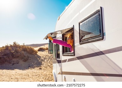 Mujer turista adulta abriendo la ventana de la camioneta para disfrutar del sol y la libertad. Concepto de personas de viaje para vacaciones de verano dentro del vehículo de autocar camping. Estilo de vida de los nómadas de la libertad