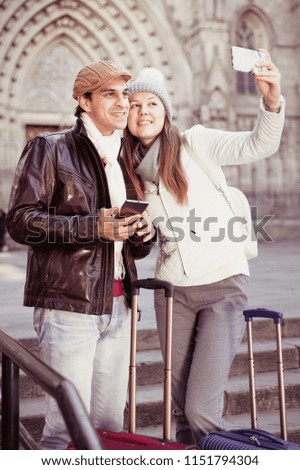 Similar – couple taking selfie in the street