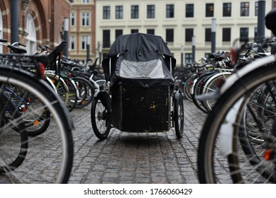 adult tricycle with tent on bicycle parking in rain