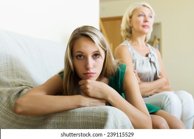 Adult Unhappy Daughter  And  Upset Mother Having Conflict On Sofa  In Home 