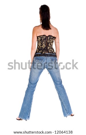 Adult woman in a black and gold corset and tight fitting blue jeans with her back to the camera