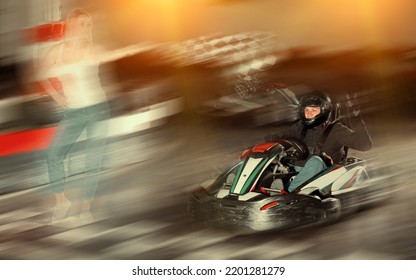 Adult Woman With Checkered Race Flag And Man Driving Sport Car For Carting