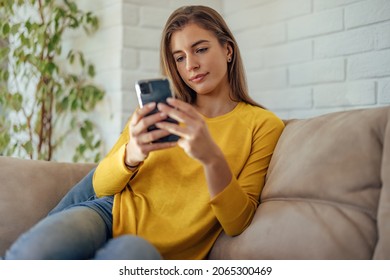 Adult Woman, Checking Her Email, On The Phone, While At Home