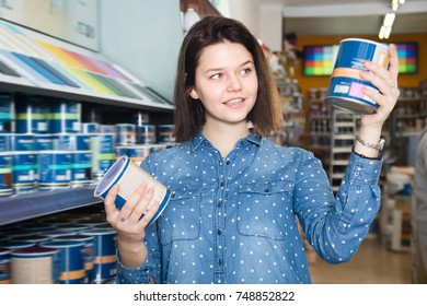 Adult Woman Choosing New Wall Paint In Paint Supplies Store