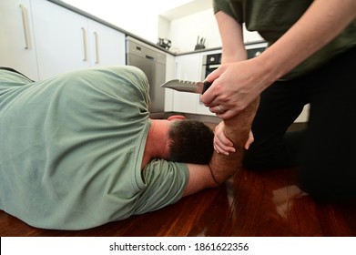 Adult woman disarming a male intruder armed with a sharp knife. - Powered by Shutterstock