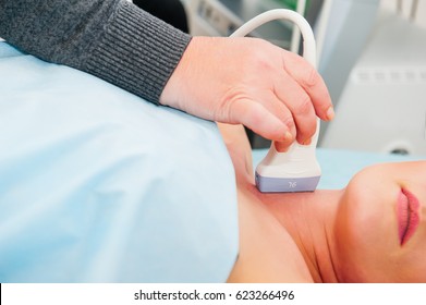 Adult Woman Doctor Scanning Vessels On The Neck With Ultrasound Device Scan. Selective Focus