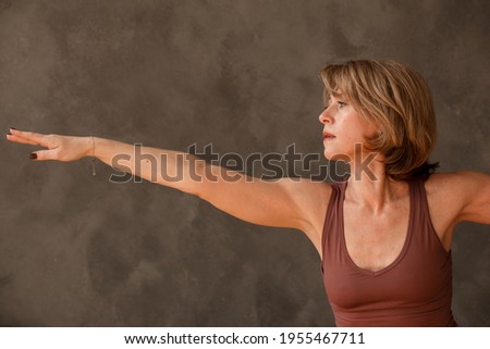 Similar – Image, Stock Photo Close up side view profile portrait of one young middle age athletic woman shadow boxing in sportswear in gym over dark background, looking away