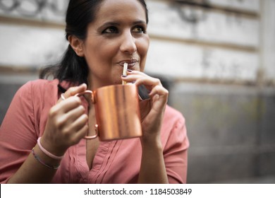 Adult Woman Drinking Moscow Mule Cocktail Outdoor Sitting In A B