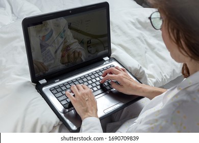 Adult Woman With Glasses, Working At Home Working At Home In Her Pijama With A Laptop And A Mobile Phone. Work From Home Concept