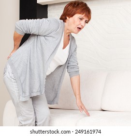 Adult Woman Has A Backache. Mature Female Has Pain In Back