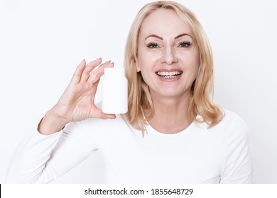 Adult Woman Holds Health Products On Her Palms And Smiles At The Camera. Adult Woman With A Bottle Of Drugs In Her Hands With A Smile On Her Face. 