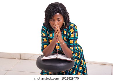 Adult Woman Kneeling Praying With Rosary And Holy Bible In Church.