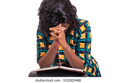 Adult Woman Kneeling Praying With Rosary And Holy Bible In Church.