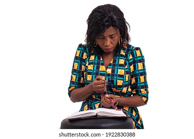 Adult Woman Kneeling Praying With Rosary And Holy Bible In Church.