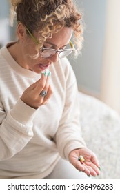 Adult Woman Middle Age Taking Pills Medicine At Home Sitting On Bed Alone - Disease And Healthy Issue Female Mature People - Lady Have Care Of Her Health Conditions