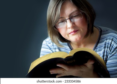 Adult Woman Reading A Bible. Close