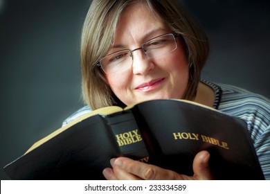 Adult Woman Reading A Bible. Close