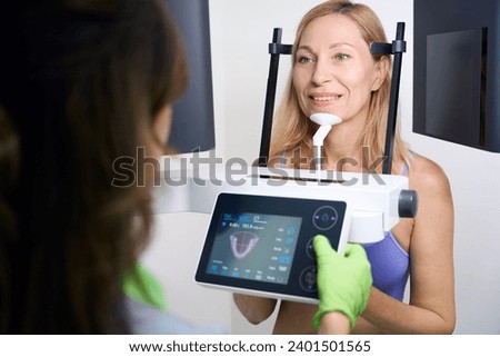 Adult woman receiving CBCT scan in dentistry clinic