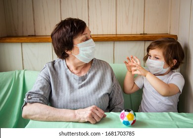 an adult woman, a retired grandmother, with a granddaughter , and wearing a medical mask, is in home quarantine, because of COVID-19 - Powered by Shutterstock