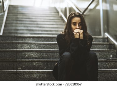 Adult Woman Sitting Look Worried On The Stairway