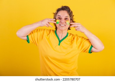 Adult Adult Woman, Soccer Fan From Brazil, Putting Paint On Her Face, Brazilian Fans. Painted Face.