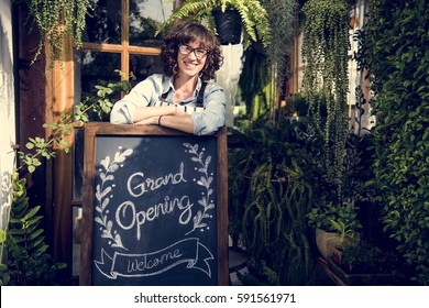 Adult Woman Standing With Grand Opening Sign