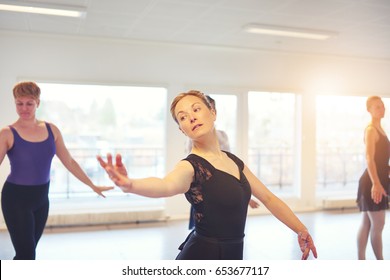 Adult Woman Standing And Posing While Dancing In Ballet Class.