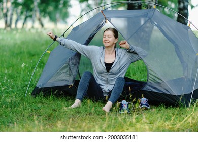 Adult woman stretching at campsite. Morning before jogging. - Shutterstock ID 2003035181