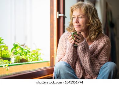 Adult Woman Taking Tea Pensive Looking Out The Window