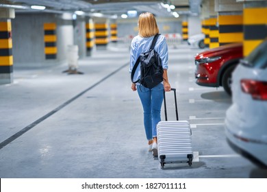 Adult Woman Tourist In Underground Airport Parking Lot