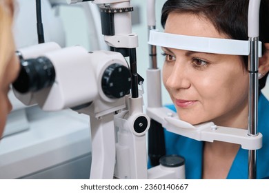 Adult woman undergoing biomicroscopy procedure at ophthalmology office - Powered by Shutterstock