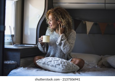 Adult Woman Working On Laptop Computer Enjoying Freedom Inside A Camper Van Alternative Van Life Home. Digital Nomad And Travel Lifestyle People Concept. Online Digital Job Business And Vacation Van