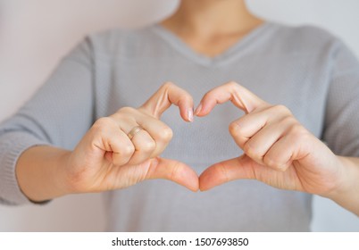 Adult woman's hand's showing heart symbol shape. Positive movememnt. - Shutterstock ID 1507693850