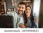 Adult young couple take a self portrait of their or have video call at home