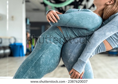 adult young girls wearing tracksuits crawling lifting legs and standing straight doing yoga exercises in the morning. Sport concept. yoga fusion of girls' bodies