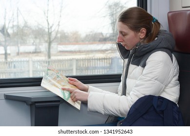 Adult Young Woman In Warm Sacual Clothes Travelling And Looking For A Route On The Map How To Get Somewhere In The Train
