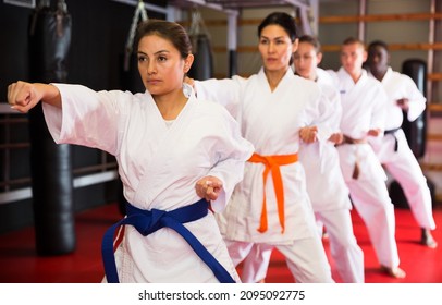 Adults In Kimono Trying New Martial Moves At Karate Class