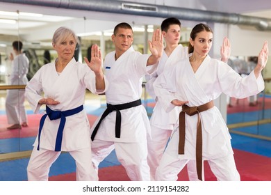 Adults In Kimono Trying New Martial Moves At Karate Class