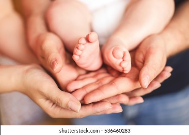 Adults Parents Hands Holding Little Baby Feet Close-up